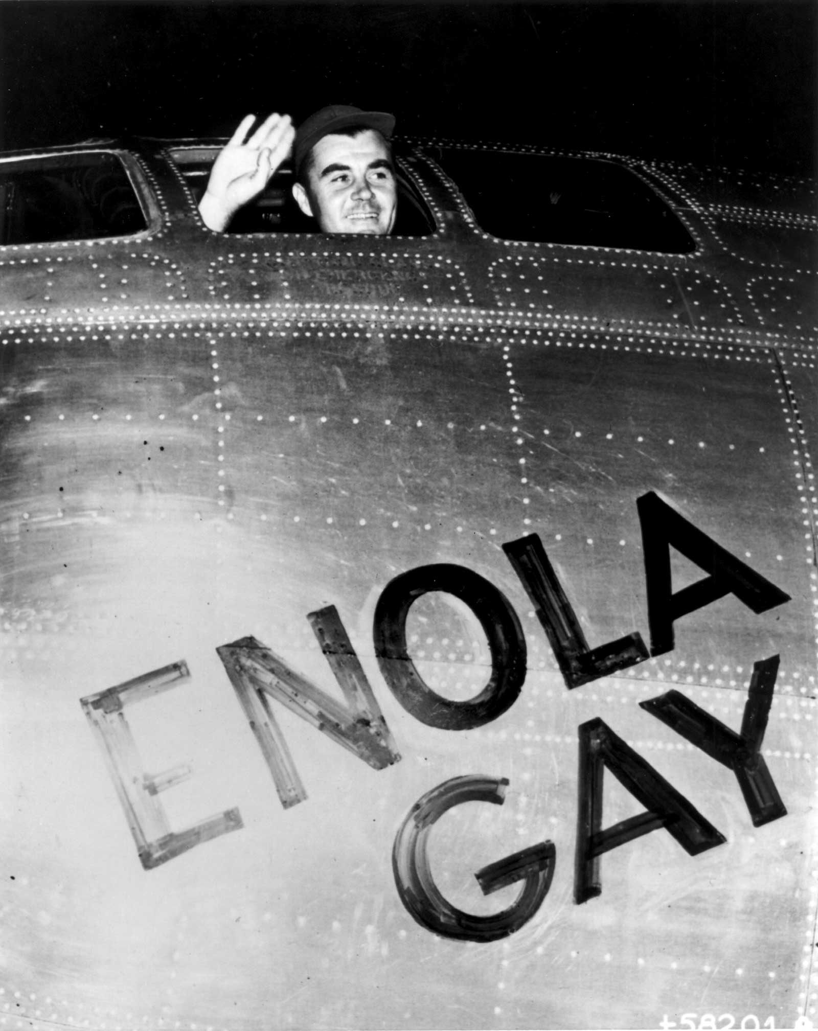 Colonel Paul Tibbets waves from the Enola Gay